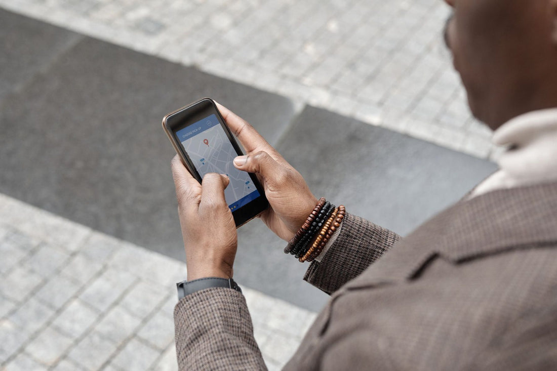 Person searching a map app on their phone on a city sidewalk, the moment local SEO is built for