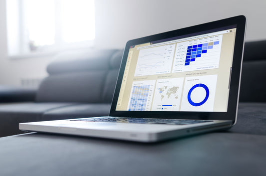 Laptop screen with traffic and ranking graphs, the growth curve an SEO budget is buying