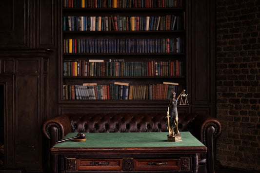 Law library with legal books, a gavel, and the scales of justice